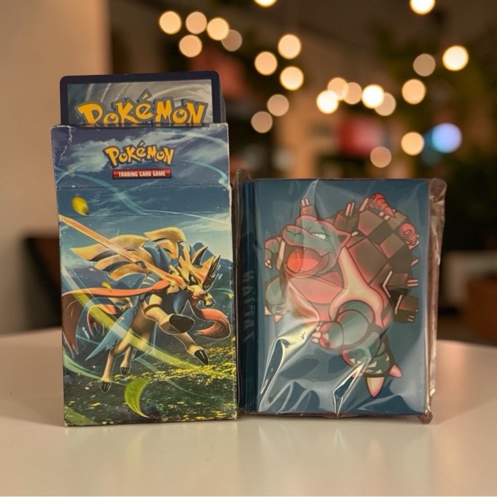 Pokemon Card Pack with Blue and Green Design and card sleeves.